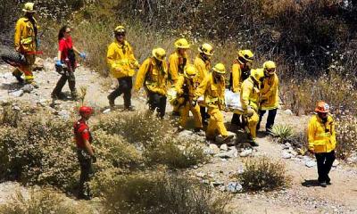 The body of a 24-year-old Pasadena resident Arturo Beristain Hernandez being carried out of in Eaton Canyon on June 30, 2009